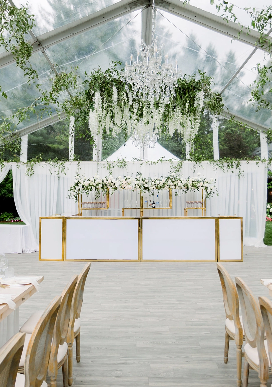 Legacy Tent from Special Event Rentals equipped with chandelier, drapes, and bar