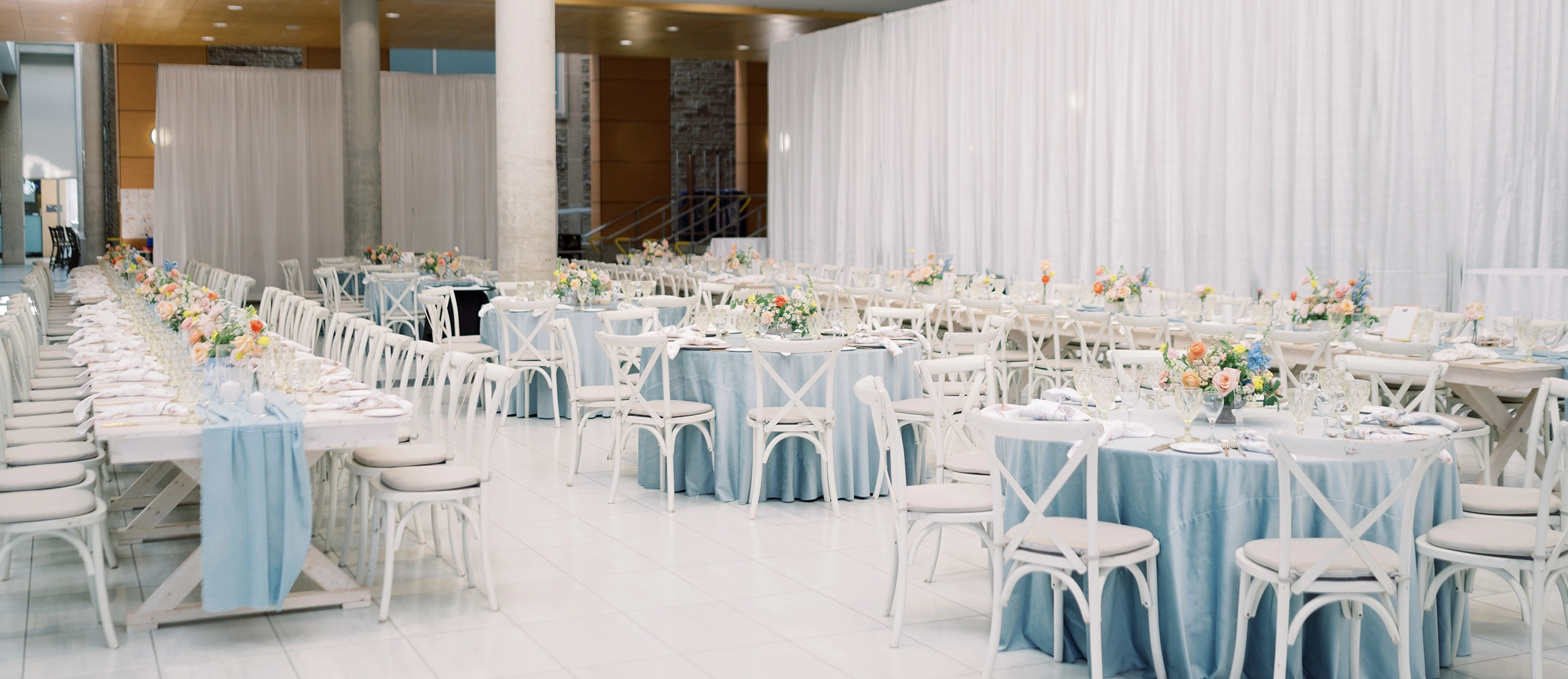 Reception table setup for McMaster Alumni Awards, white linens with baby blue accents