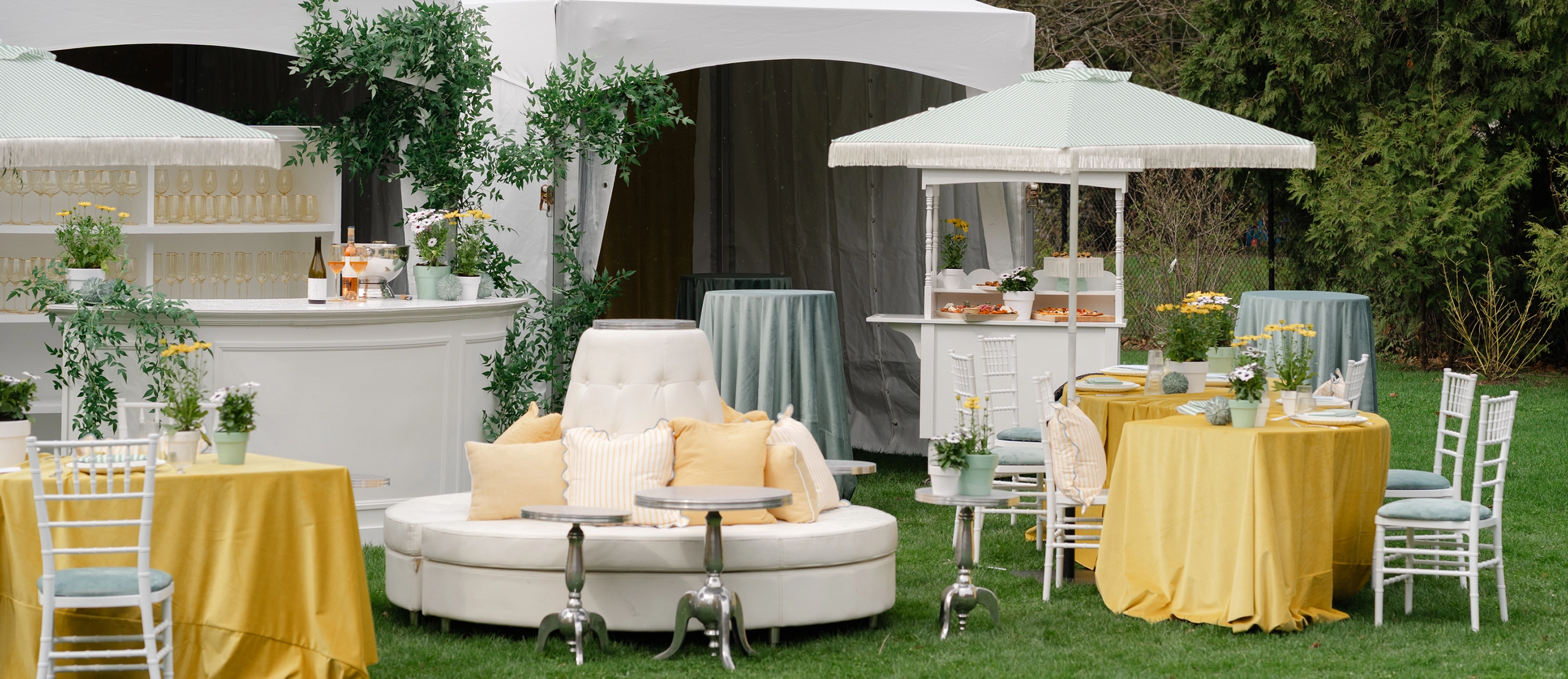 Dining tables setup beside High-Peak bar tents