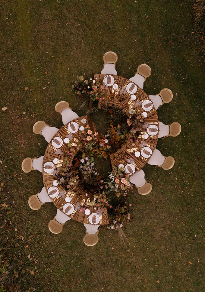 Outdoor dinner table setup with rustic table linen rentals and chairs