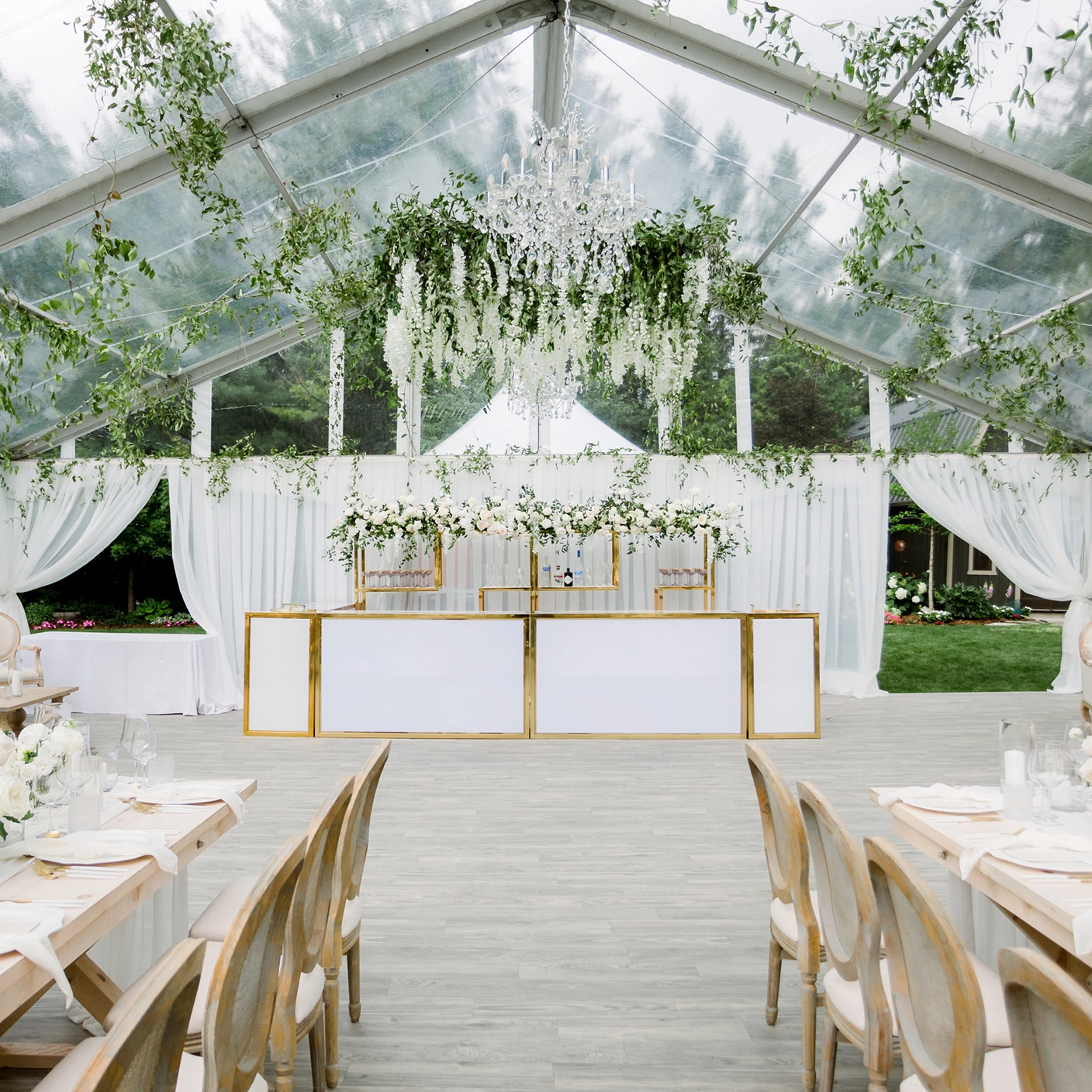 Legacy Tent from Special Event Rentals equipped with chandelier, drapes, and bar 