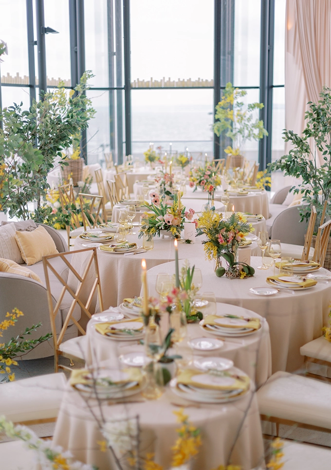 Beautiful wedding reception setup with light peach table linens and peach colour florals