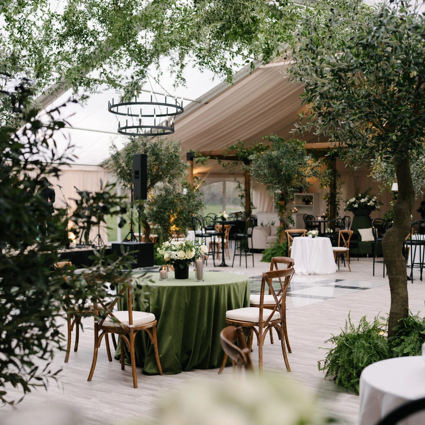Woodsy-themed wedding setup inside a Legacy Tent from Special Event Rentals