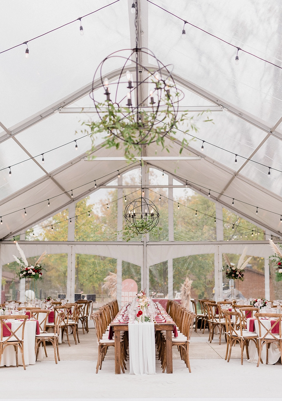A 30ft legacy tent setup with string lights and iron globe light fixture