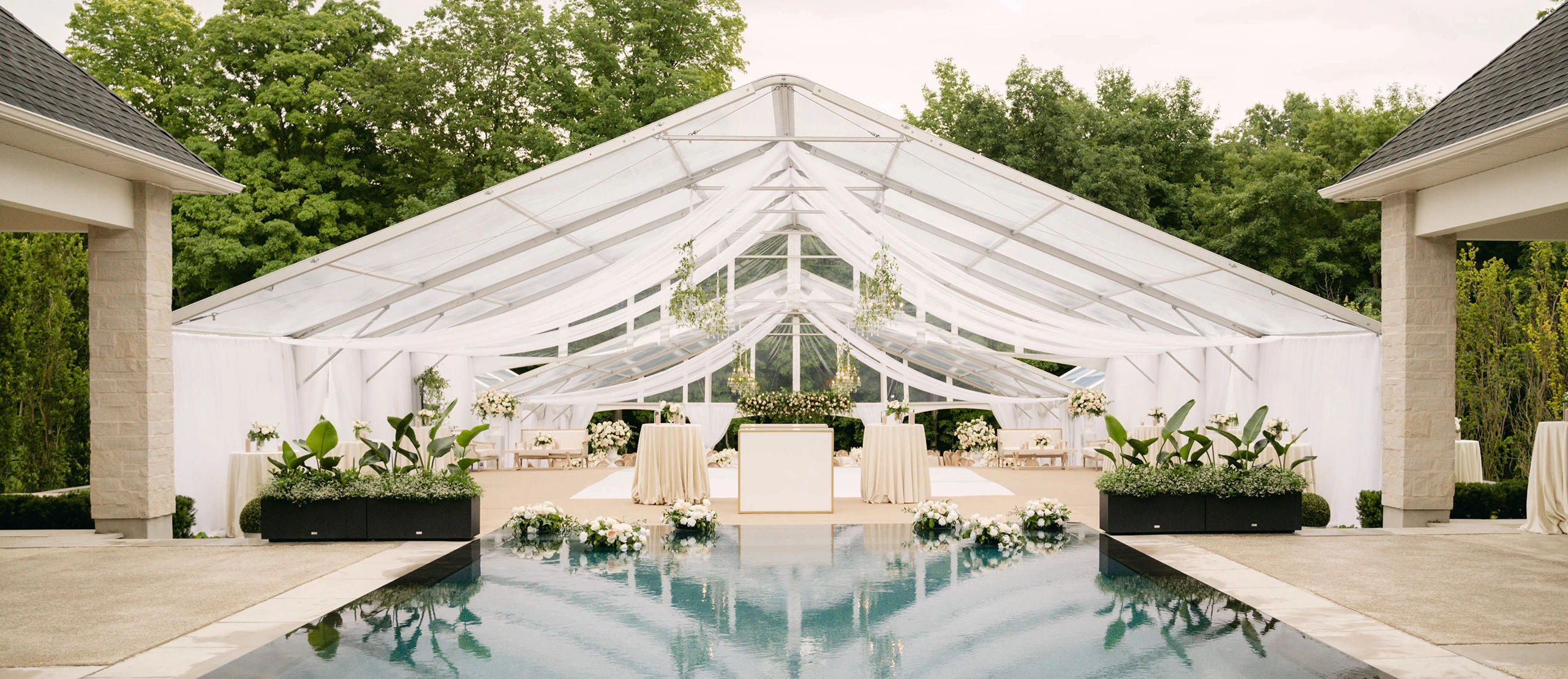 Legacy Tent from Special Event Rentals setup at outdoor event with white linen treatments
